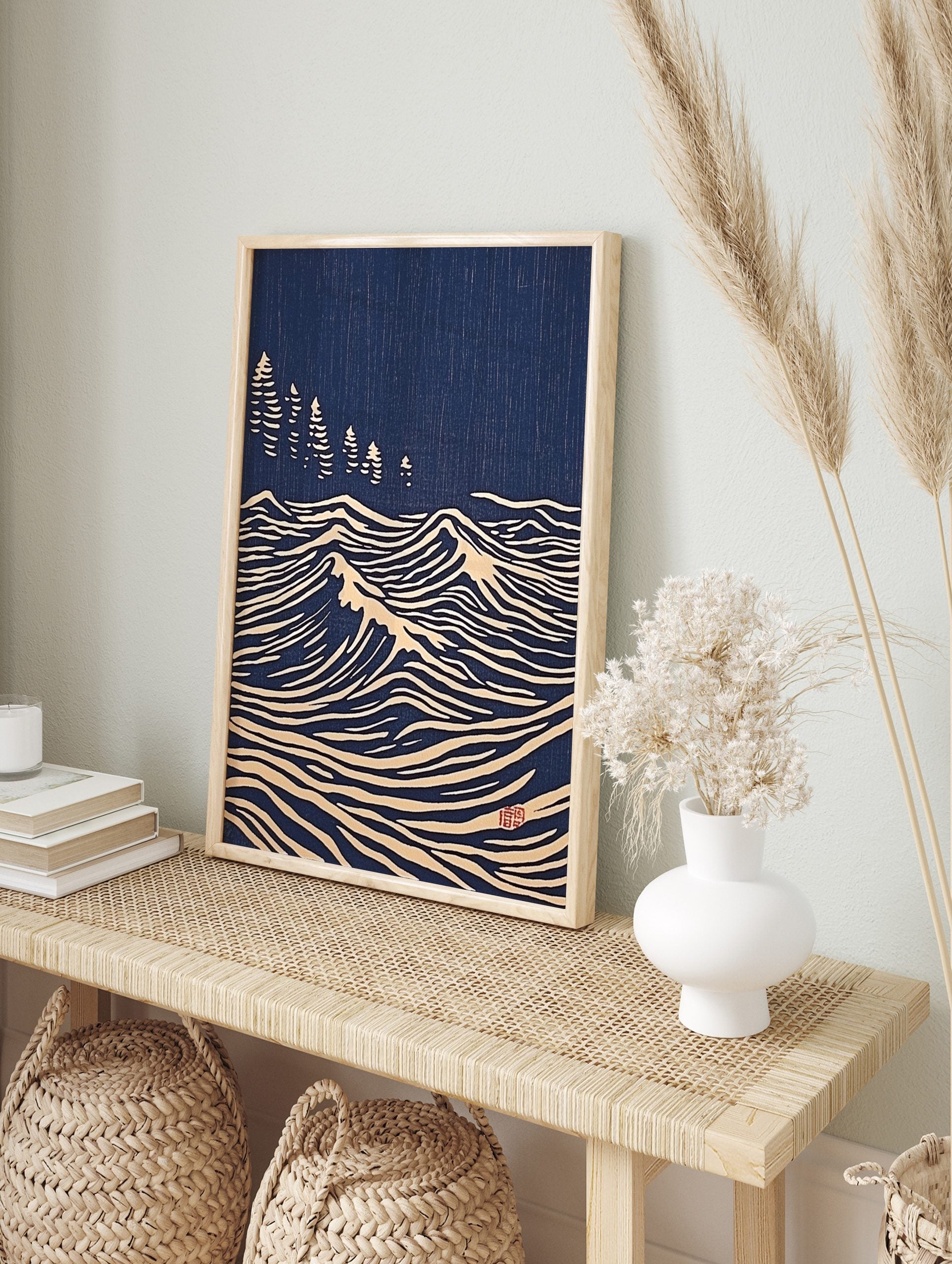 Japanese woodblock print style art with white stylised ocean waves and pine trees on a deep, in an alternate framed mockup