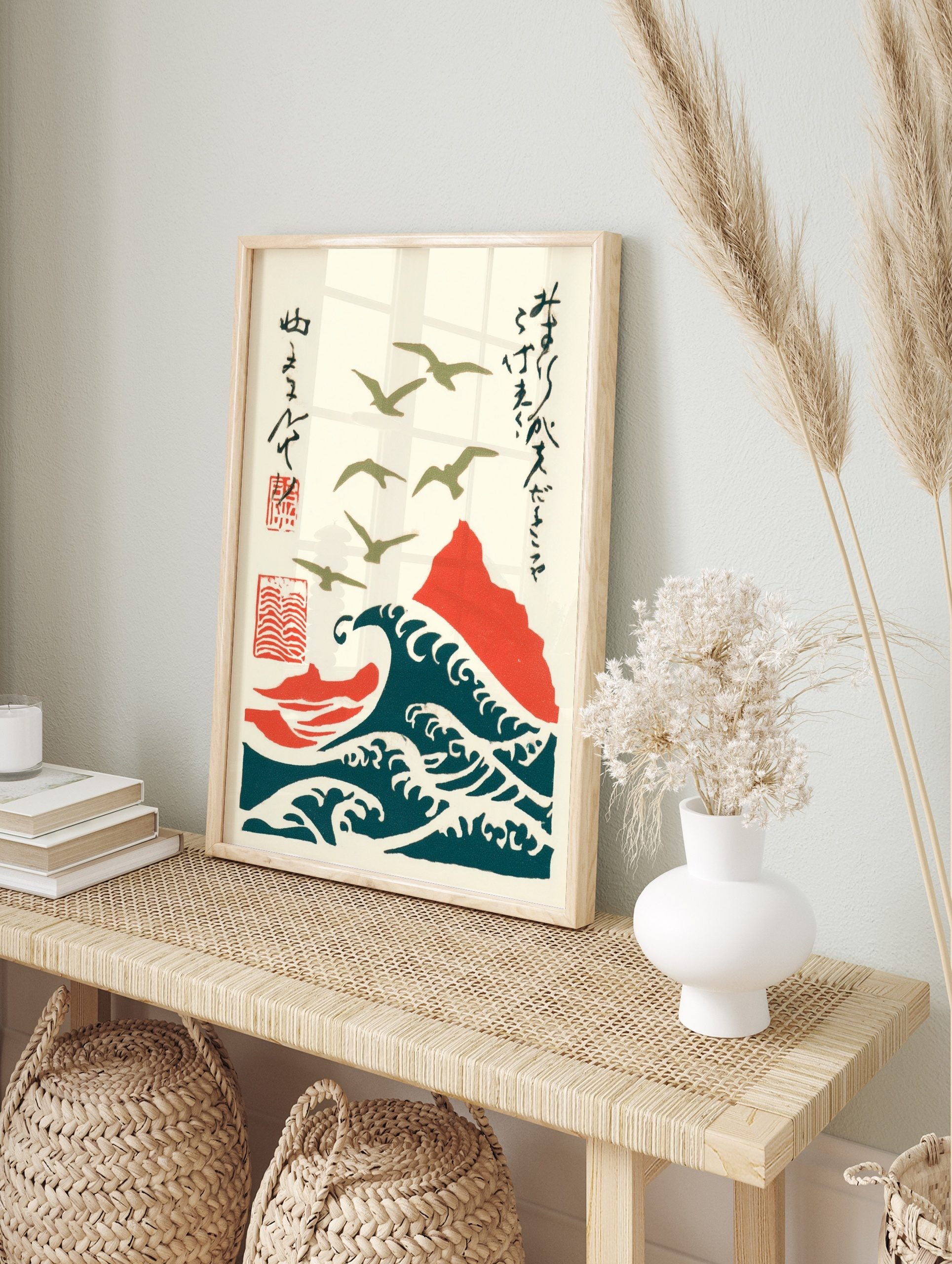 Japanese woodblock style art of olive green seagulls flying over deep teal waves and a red, in an alternate framed mockup