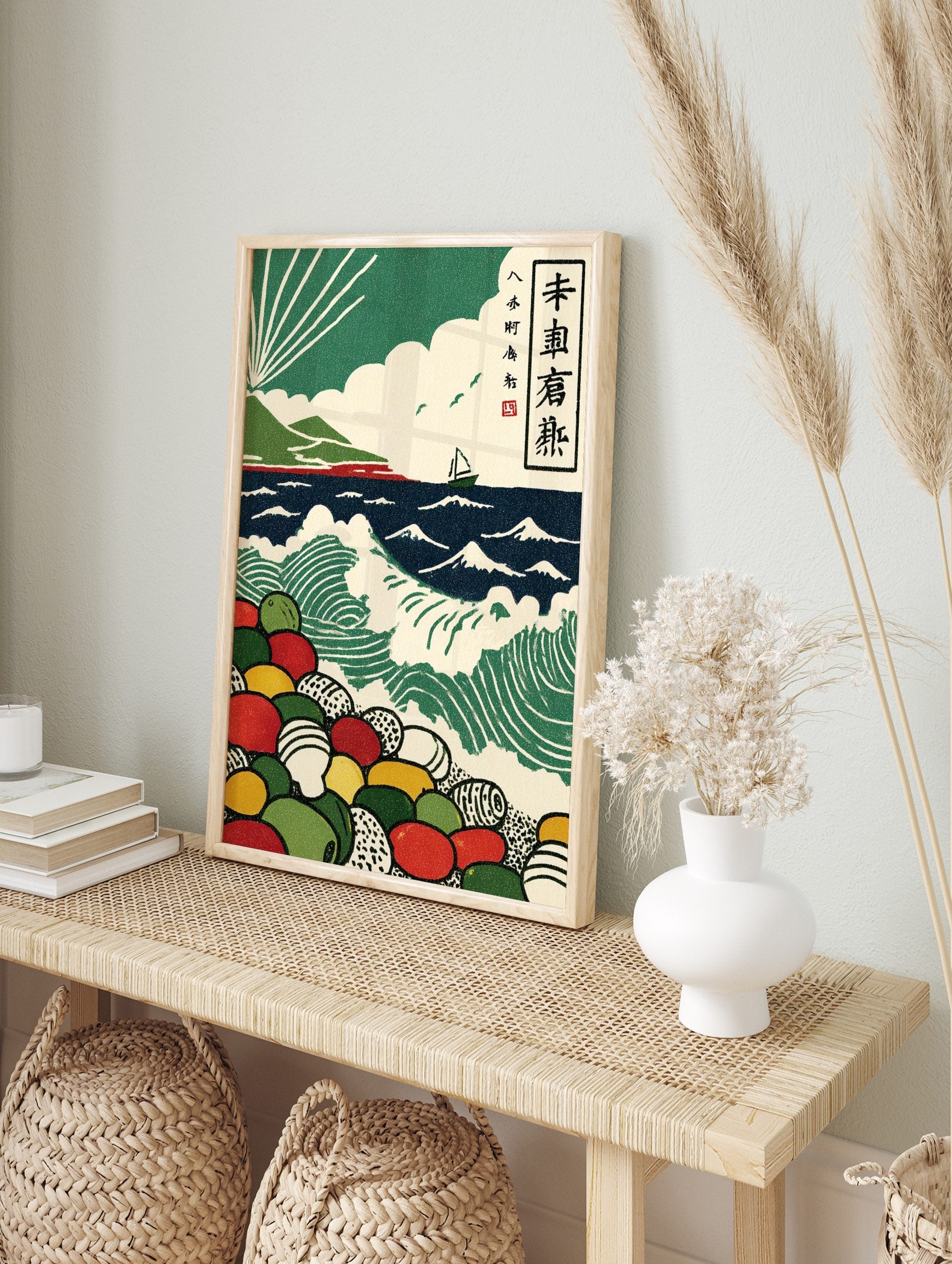 Japanese woodblock seascape print with green waves, sailboat, mountains, sun rays, and, in an alternate framed mockup