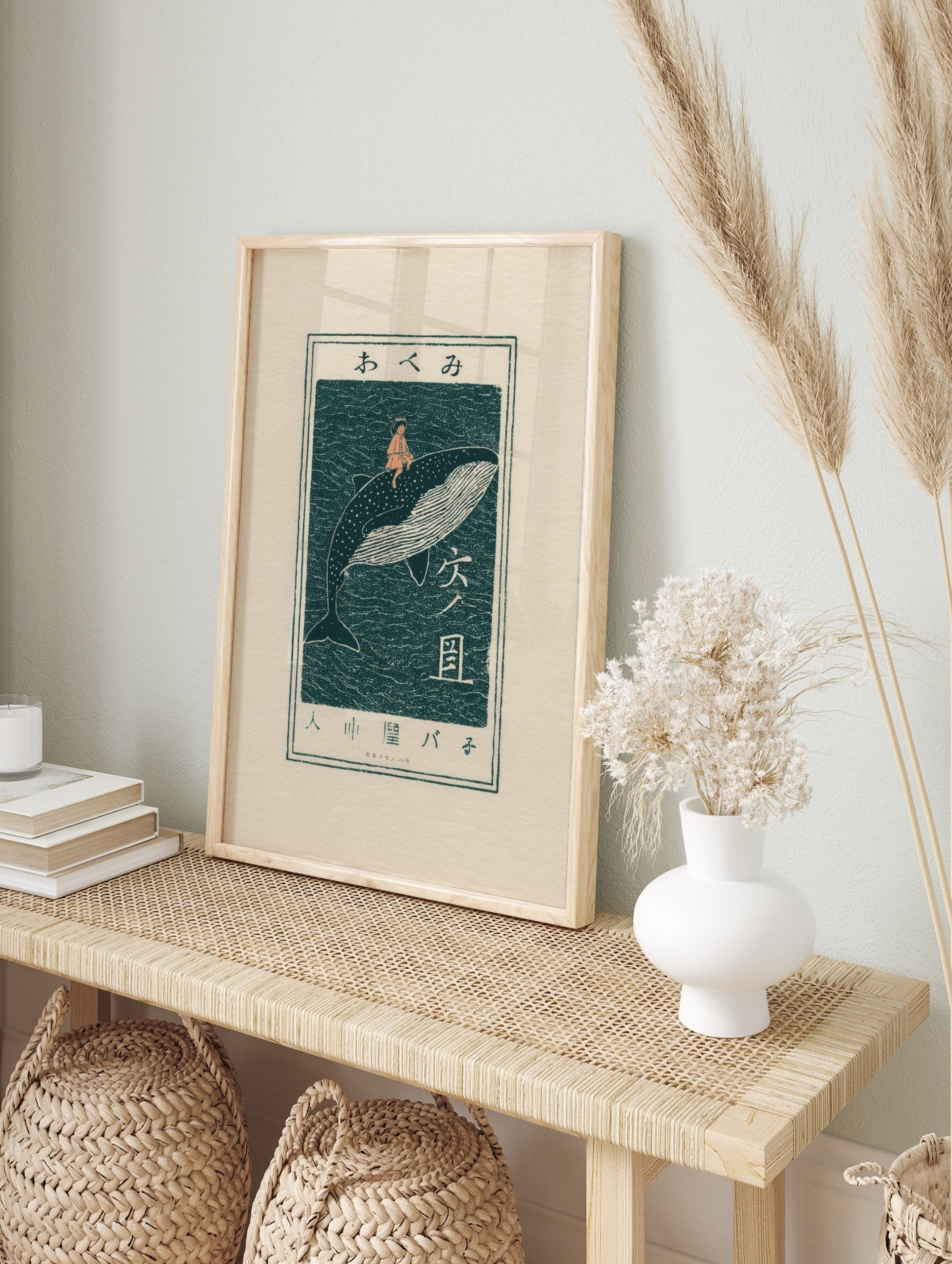 Japanese woodblock art print of a child riding a whale in dark teal and peach, with Japanese, in an alternate framed mockup
