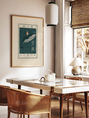 Japanese woodblock art print of a child riding a whale in dark teal and peach, with Japanese text, in a styled room mockup