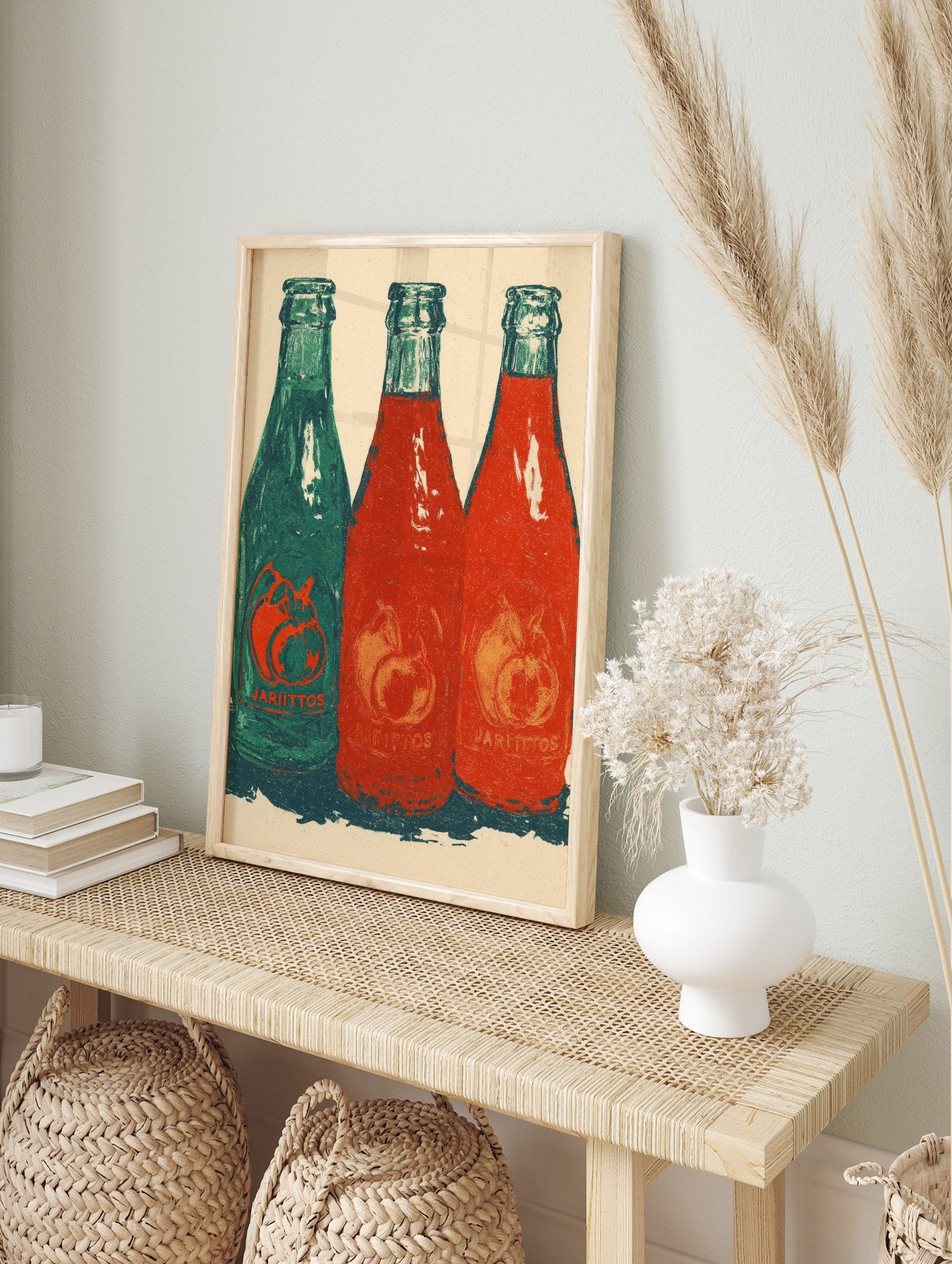 Three Jarritos soda bottles, one green and two red, with fruit motifs and 'JARIITOS' text, in, in an alternate framed mockup