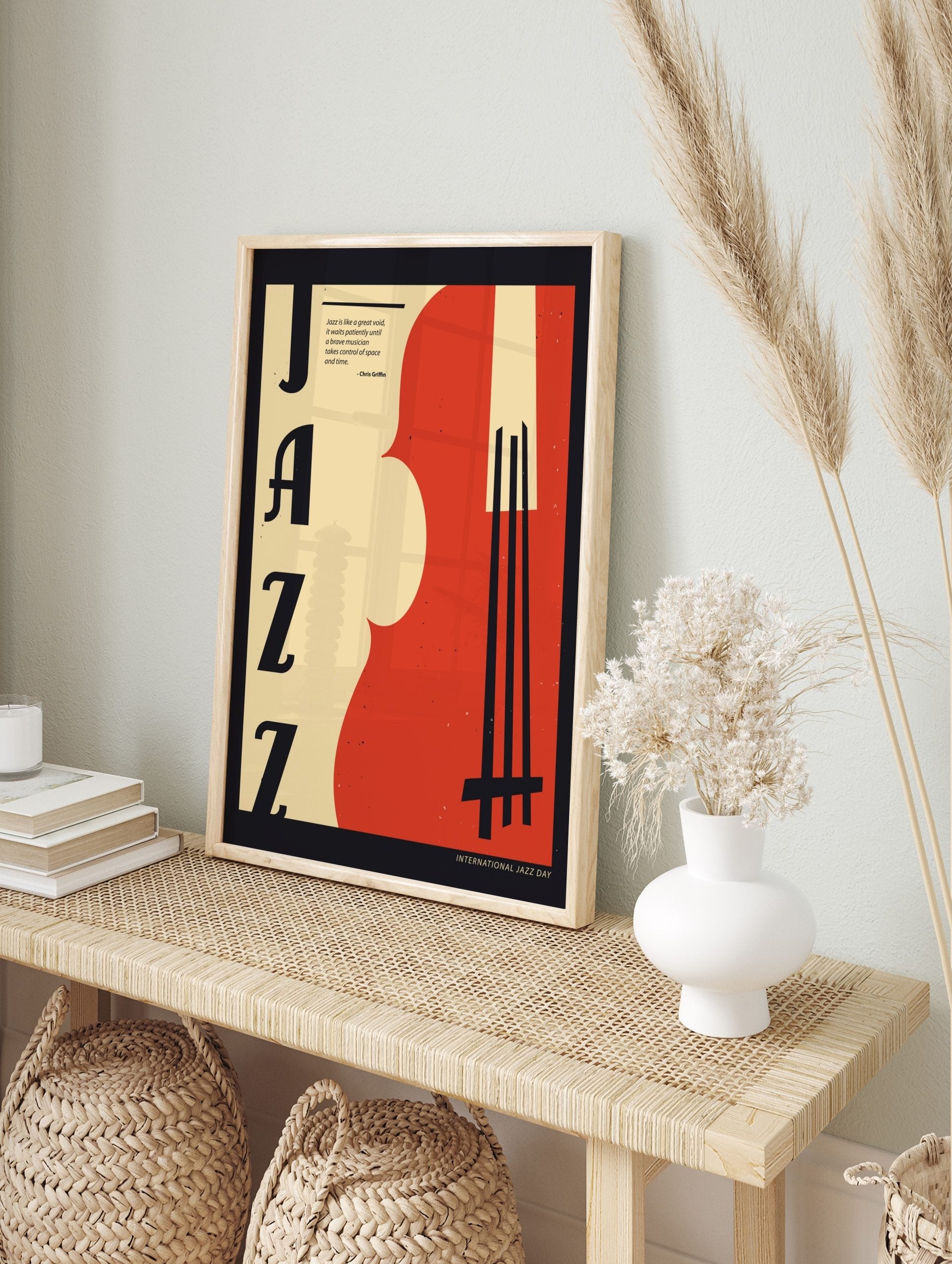 Retro Jazz art poster with large black 'JAZZ' typography, a red and beige abstract double bass, and a music quote, displayed as the same artwork in an alternate framed wall art mockup