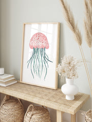 Pink jellyfish watercolour illustration with teal tentacles on a white background, in an alternate framed mockup