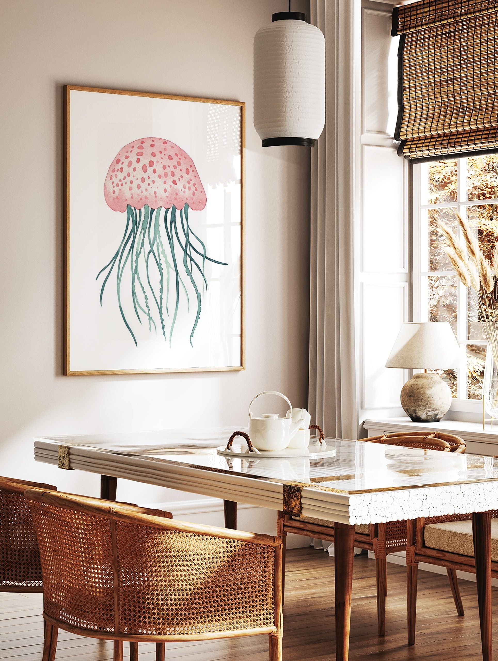 Pink jellyfish watercolour illustration with teal tentacles on a white background, in a styled room mockup