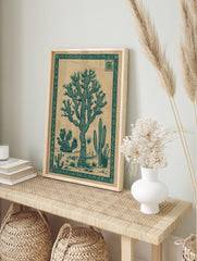 Joshua Tree cactus botanical illustration in dark teal on a beige background with an ornate, in an alternate framed mockup