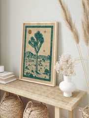 Illustrated Joshua Tree desert landscape poster with teal tree, mountains, and gold suns, framed by an ornate border. - Image 4