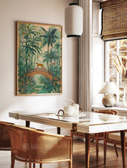 Illustrative jungle art print with a ginger big cat walking on an arched bridge amidst green palm, in a styled room mockup