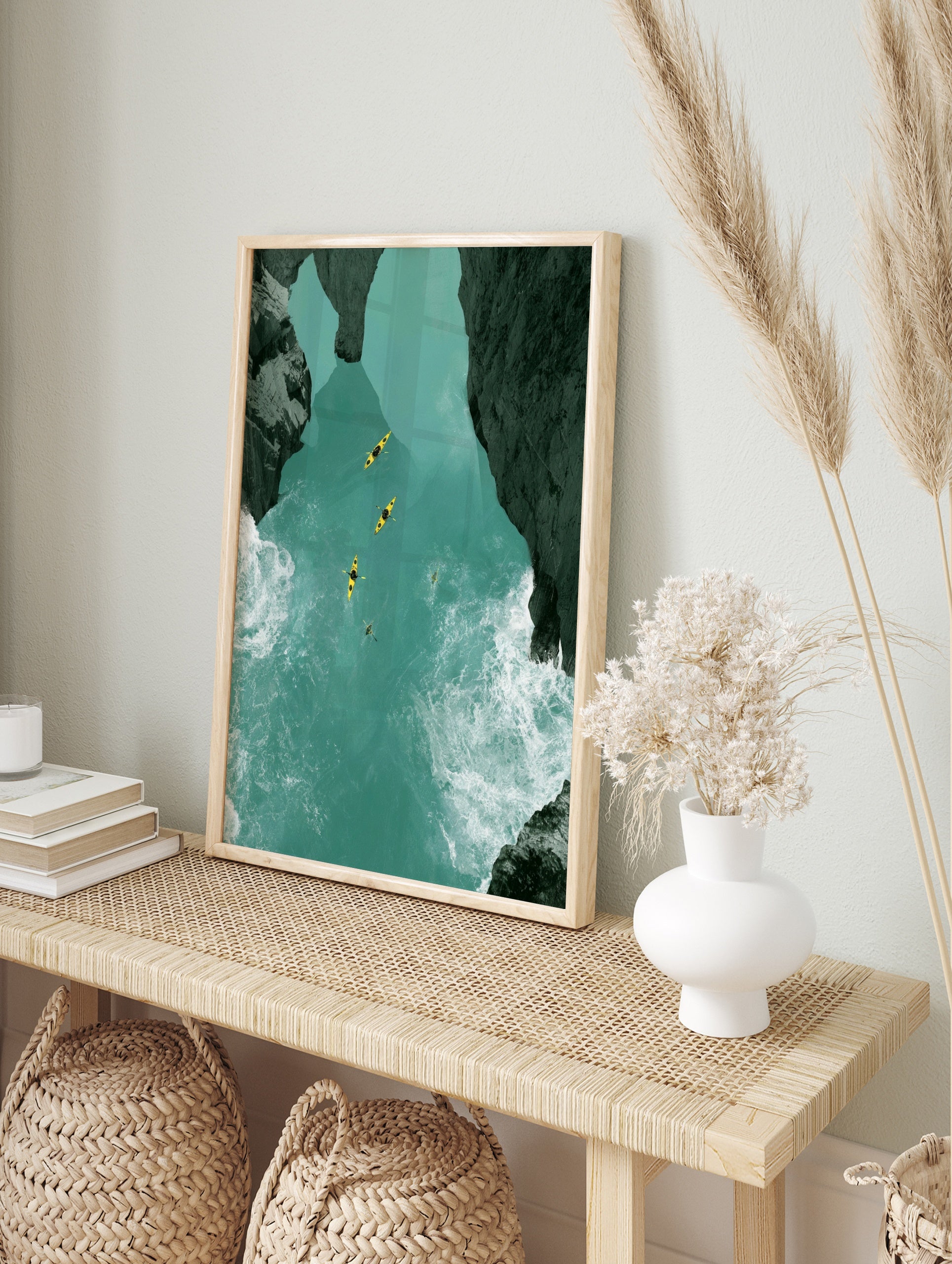 Aerial view of four yellow kayaks on a turquoise river canyon with dark rocky cliffs and, in an alternate framed mockup