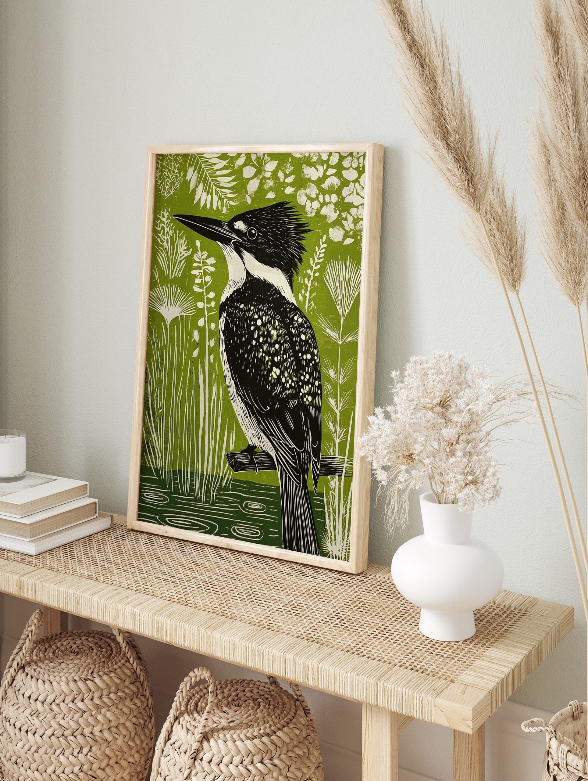 Linocut-style art print of a black and white kingfisher bird on a branch, vibrant green, in an alternate framed mockup