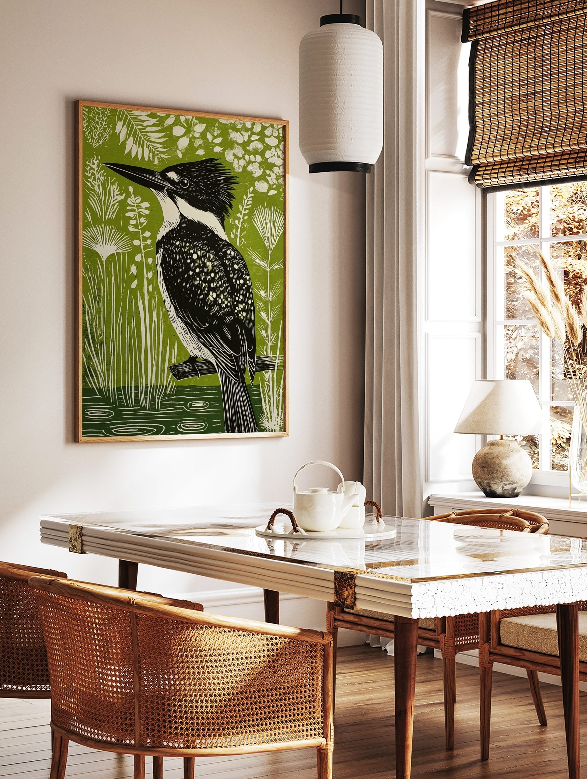 Linocut-style art print of a black and white kingfisher bird on a branch, vibrant green background, in a styled room mockup