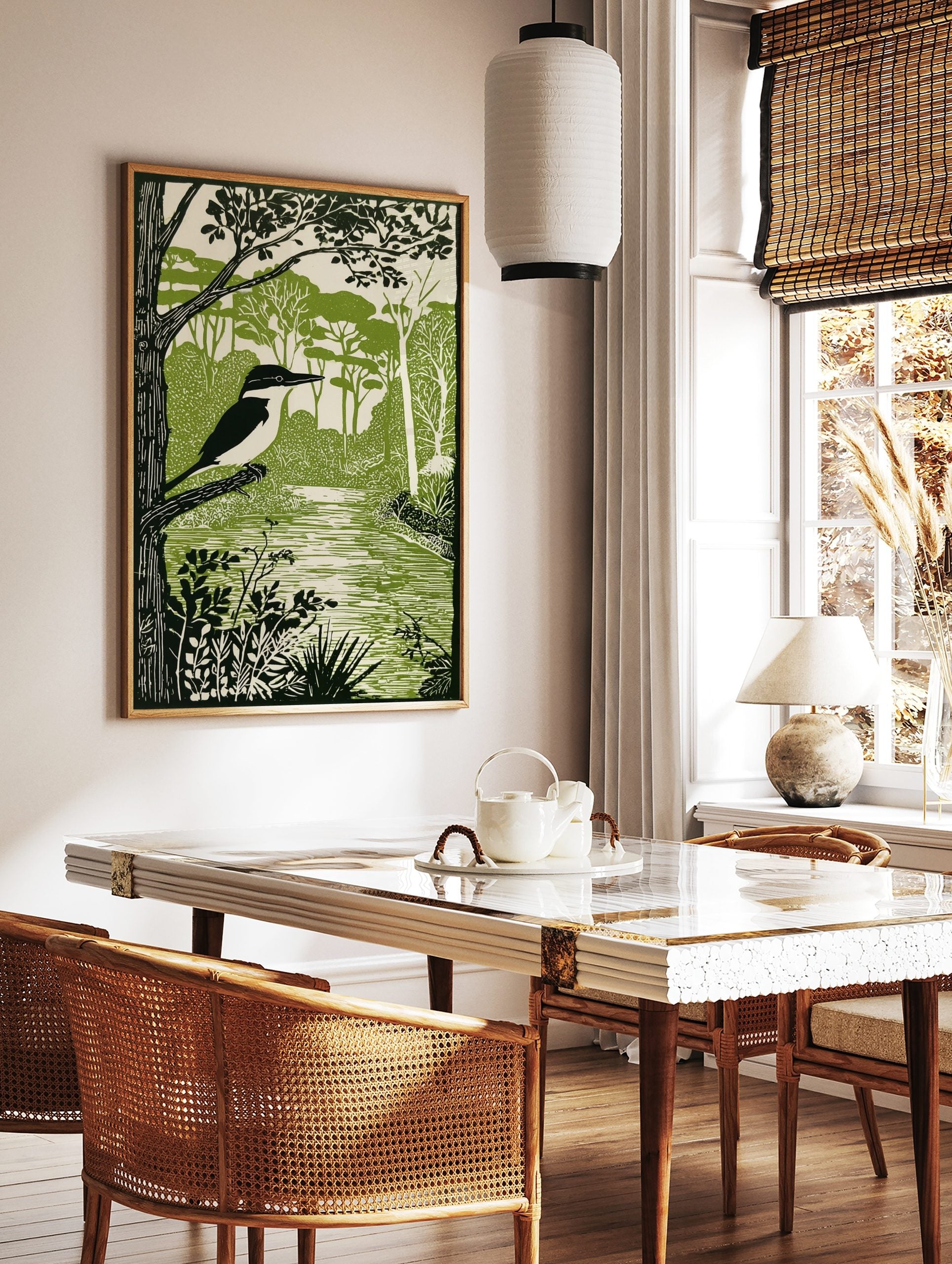 Linocut style kingfisher bird perched on a branch by a river, surrounded by green trees and foliage, in a styled room mockup