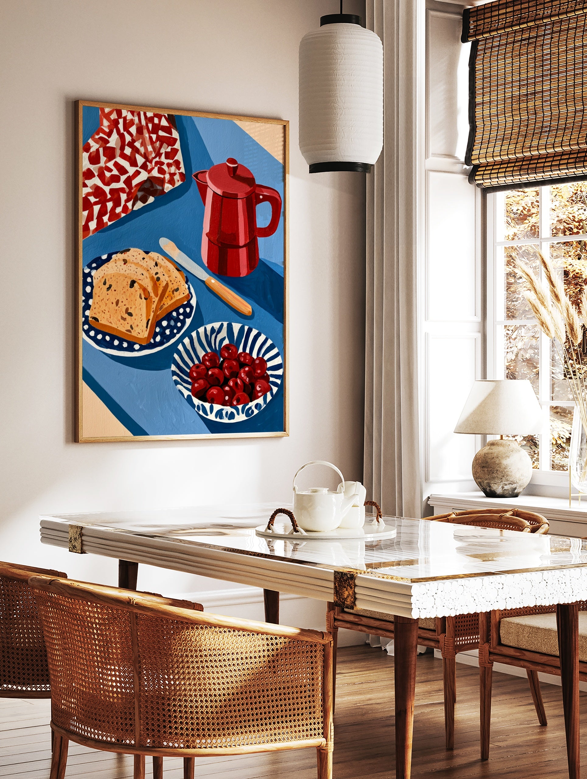 Still life wall art print featuring a red moka pot, fruit bread slices, and a bowl of cherries on a, in a styled room mockup