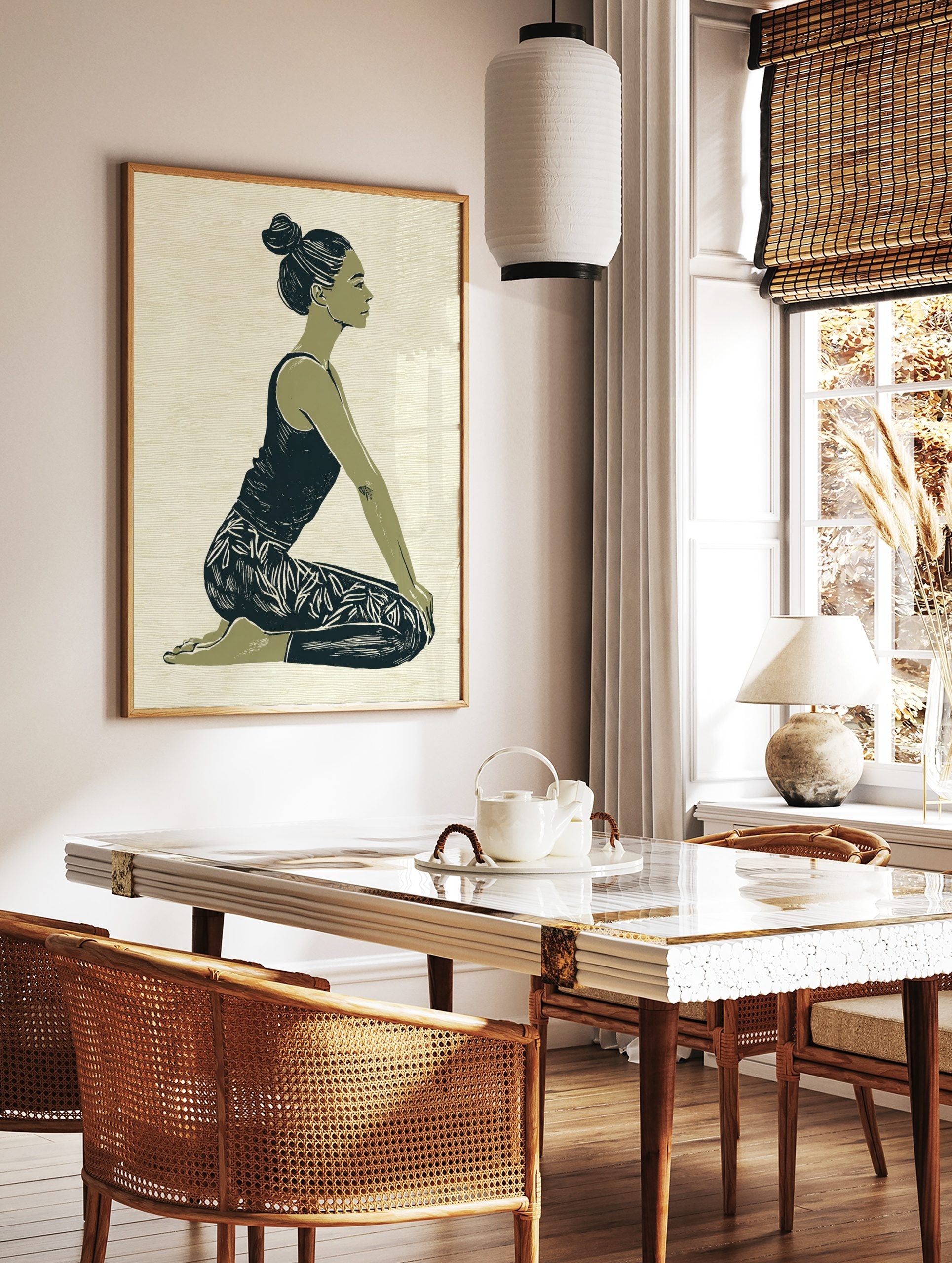 Illustrative print of a woman in a kneeling yoga pose, green and navy palette on textured beige, in a styled room mockup