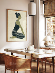 Illustrative print of a woman in a kneeling yoga pose, green and navy palette on textured beige, in a styled room mockup