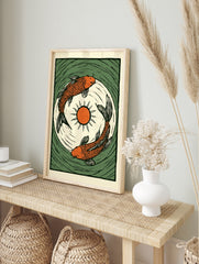 Illustrative orange koi carp fish print with central sun and green water ripples in a woodcut, in an alternate framed mockup