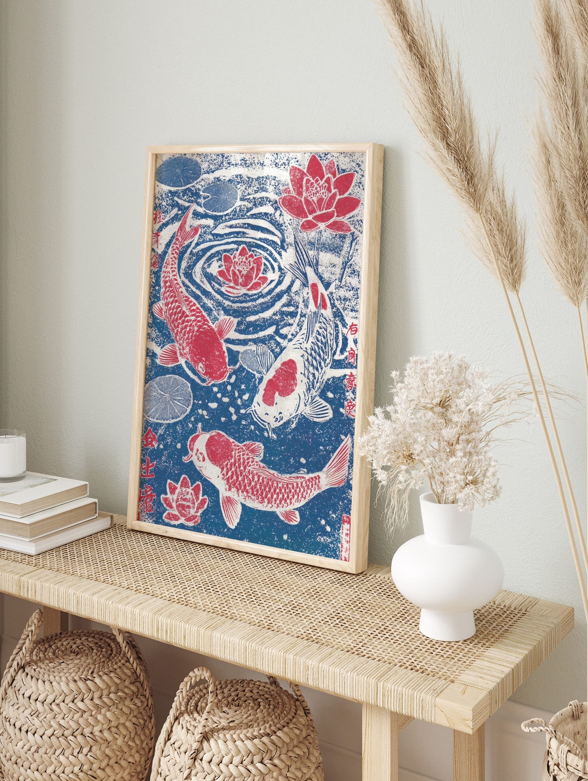 Japanese woodblock style print of three red and white koi fish swimming with red lotus, in an alternate framed mockup