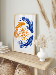Illustrative koi fish in blue and orange swimming in a circle around a yellow sun on white, in an alternate framed mockup