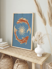Illustrative wall art print of two koi fish swimming in a circle around a sun, terracotta, in an alternate framed mockup