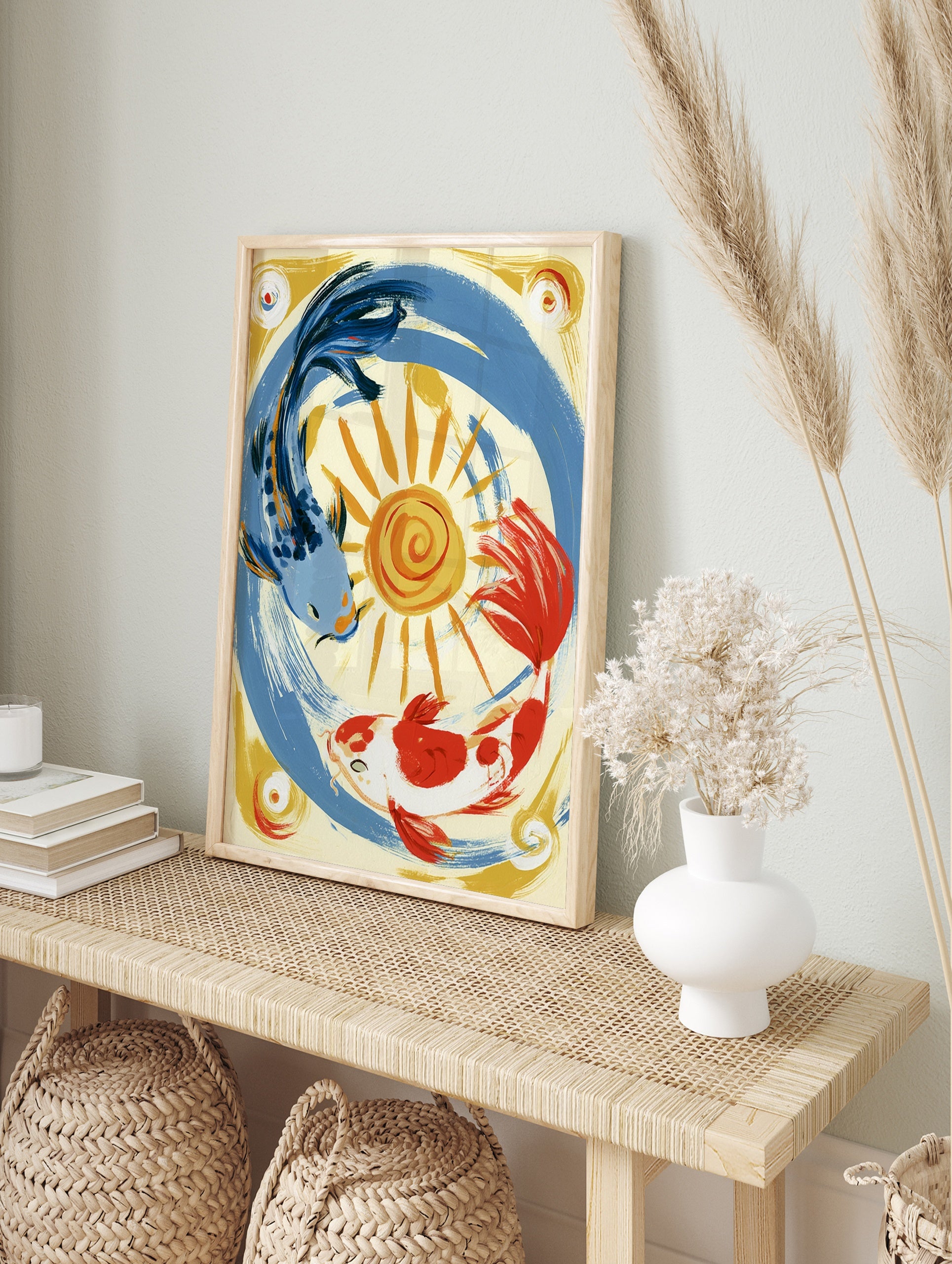 Stylised illustration of a blue koi and an orange koi fish circling a yellow sun on a cream, in an alternate framed mockup