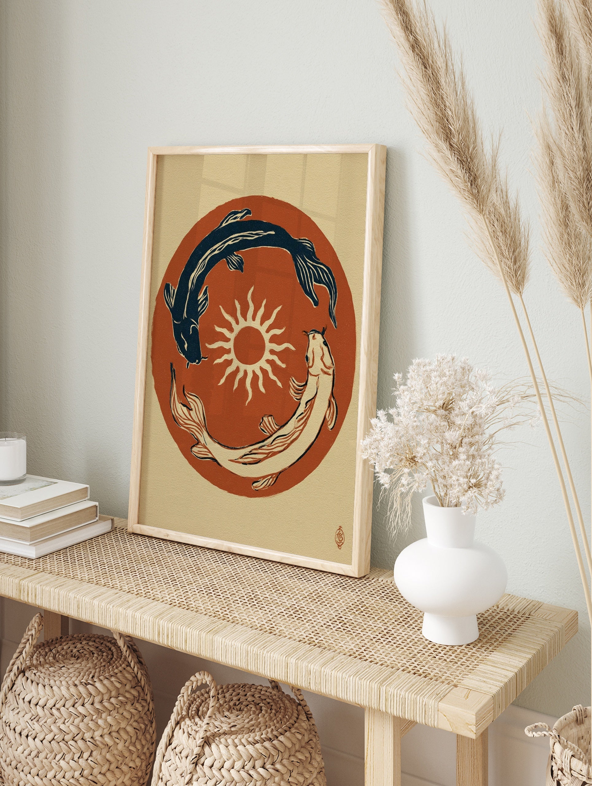 Japanese style illustration of two koi fish circling a sun on a terracotta background, in an alternate framed mockup