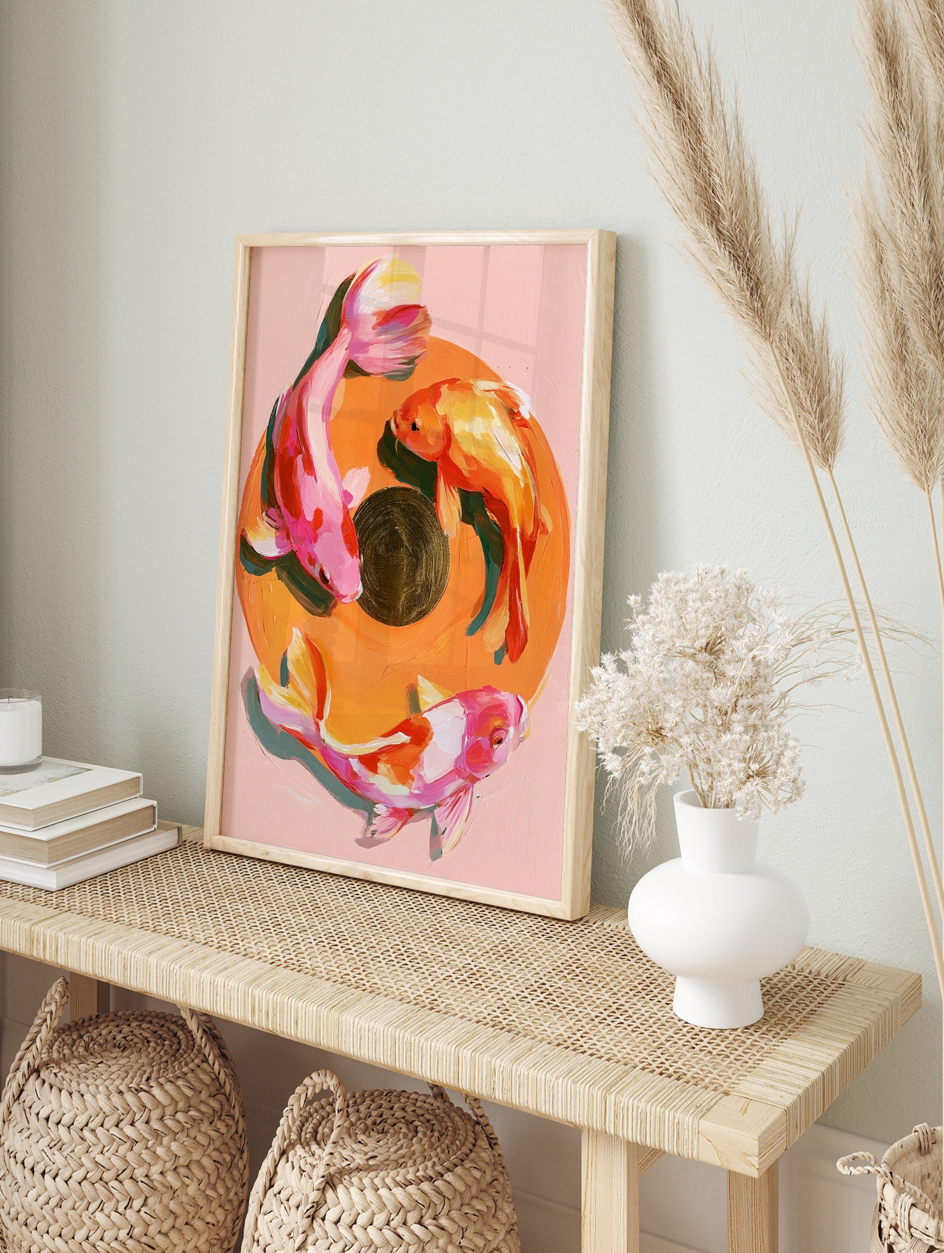 Painterly koi fish wall art print with three fish in a circular composition on a soft pink, in an alternate framed mockup