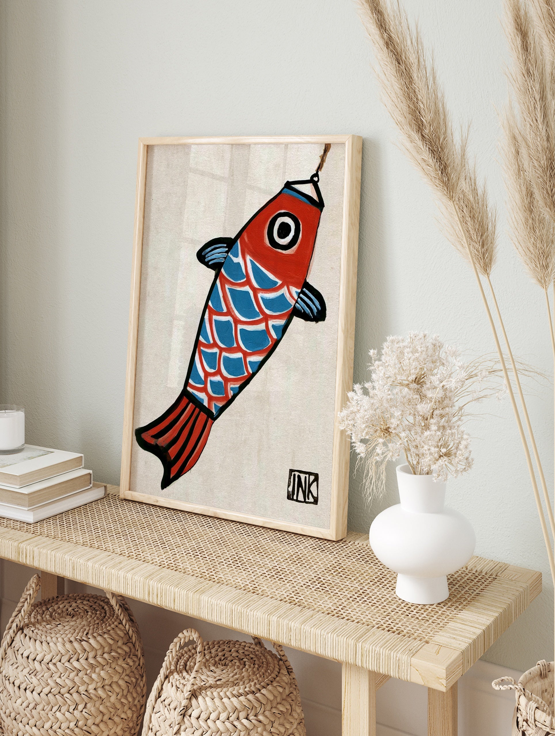 Stylized koi fish illustration with red head, blue scales, and black outlines, hanging from a, in an alternate framed mockup