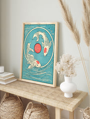 Japanese style koi fish wall art with two fish swimming in a circle around a red sun on a, in an alternate framed mockup