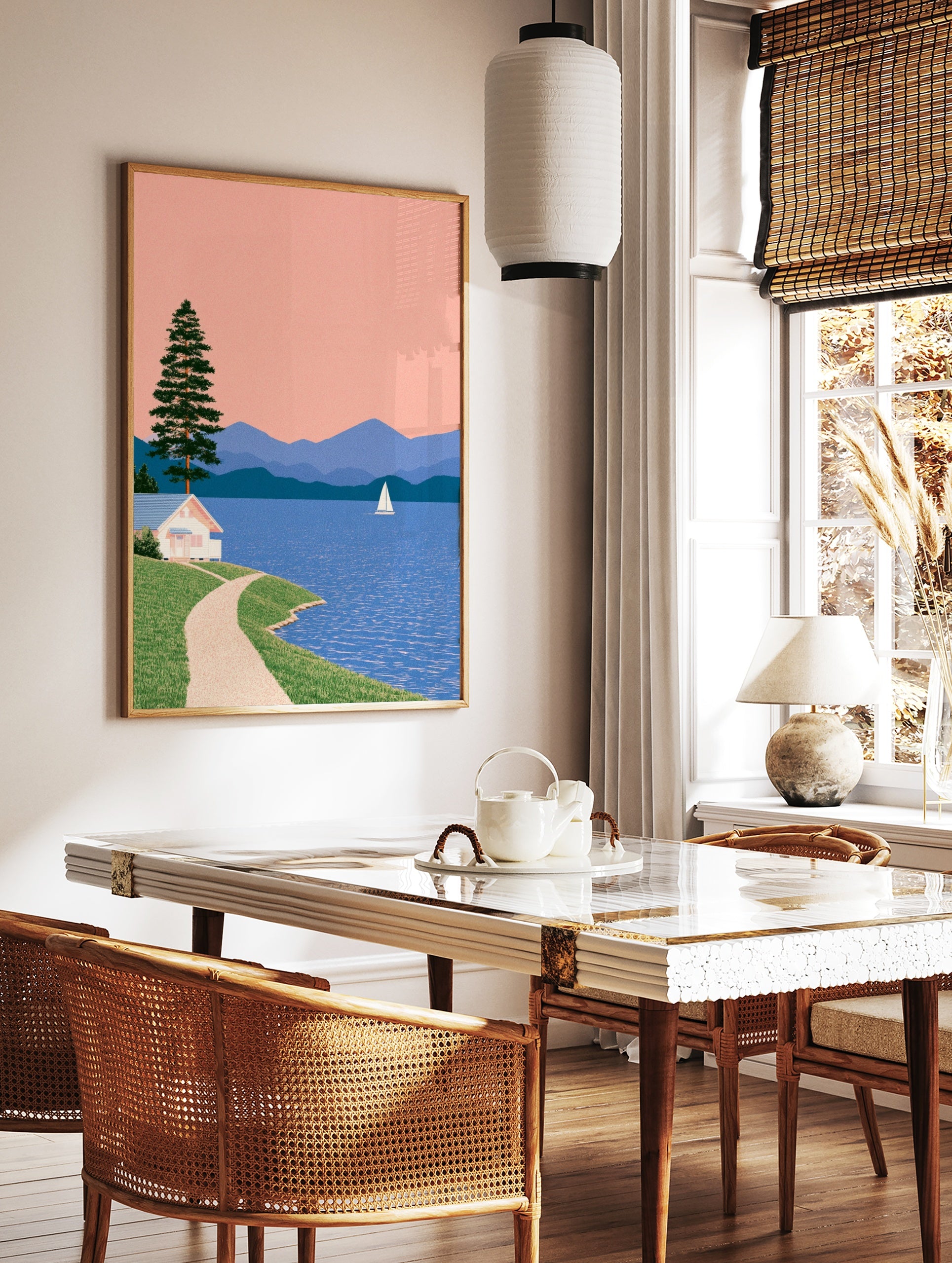 Illustrative lakeside landscape with a white cottage, pine tree, sailboat, and blue mountains under, in a styled room mockup
