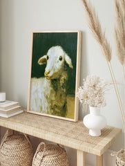 Oil painting style art print of a white lamb against a dark, moody background, in an alternate framed mockup