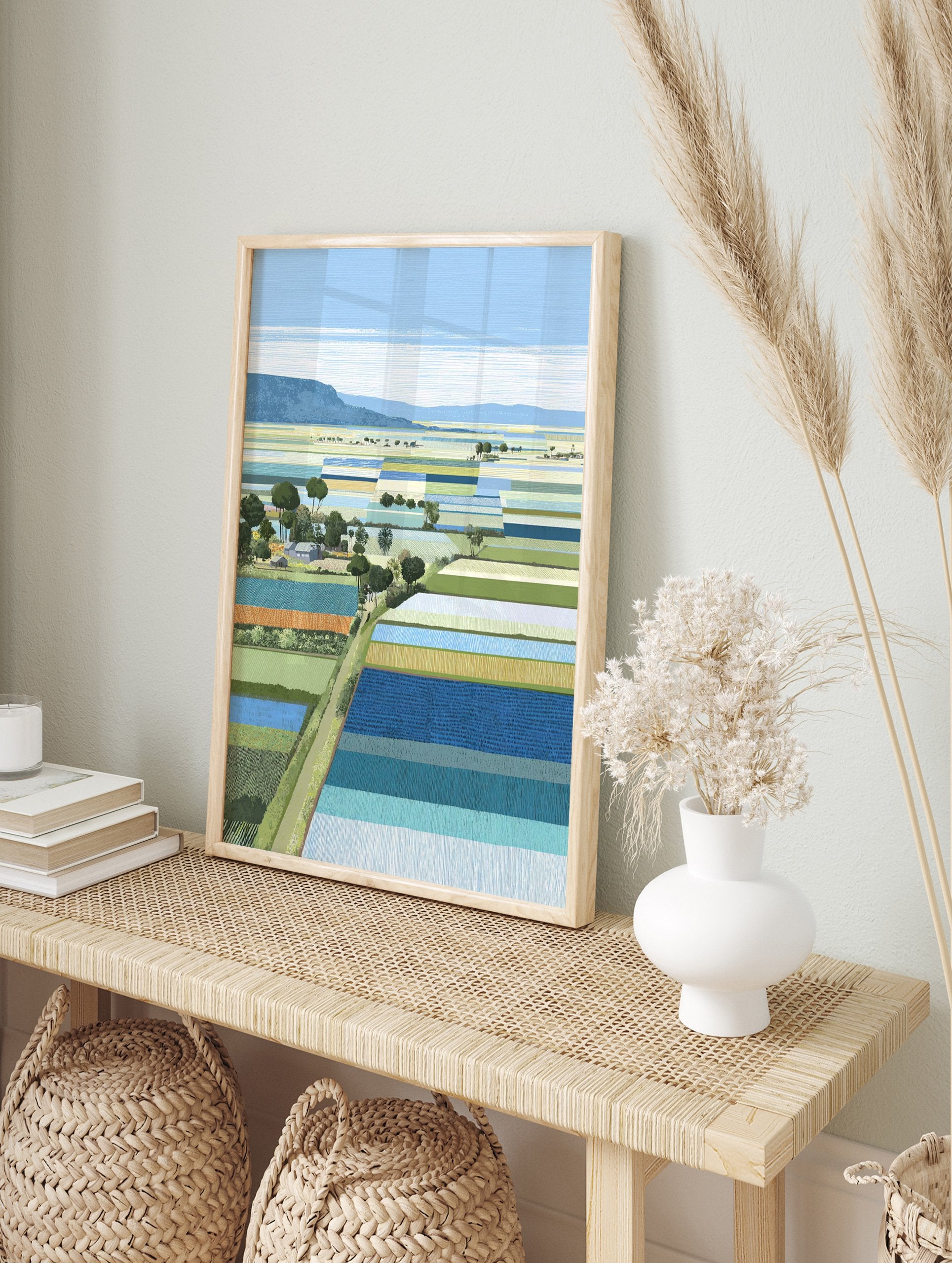 Modern illustrative Landscape Wall Art depicting colorful patchwork farm fields, trees, and distant hills under a blue sky. - Image 3