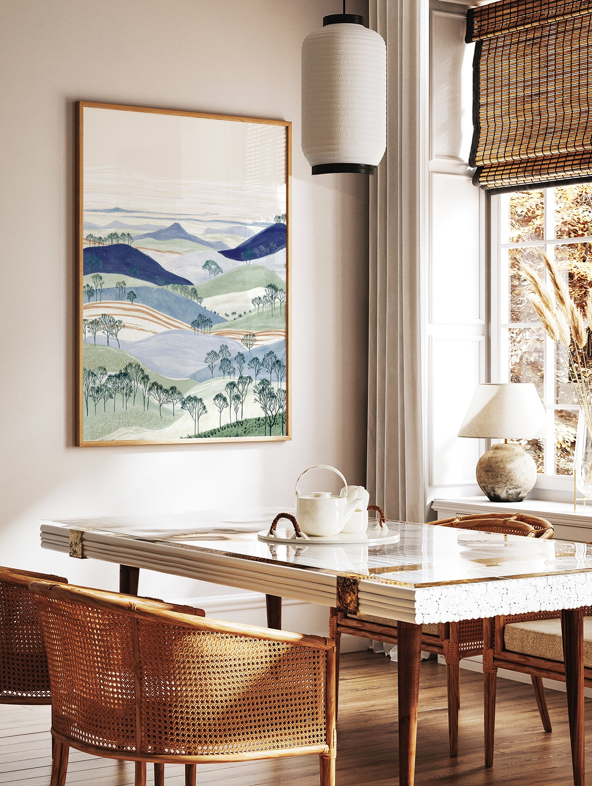 Illustrated landscape wall art with layered blue and green hills, bare trees, and a pale sky. - Image 2