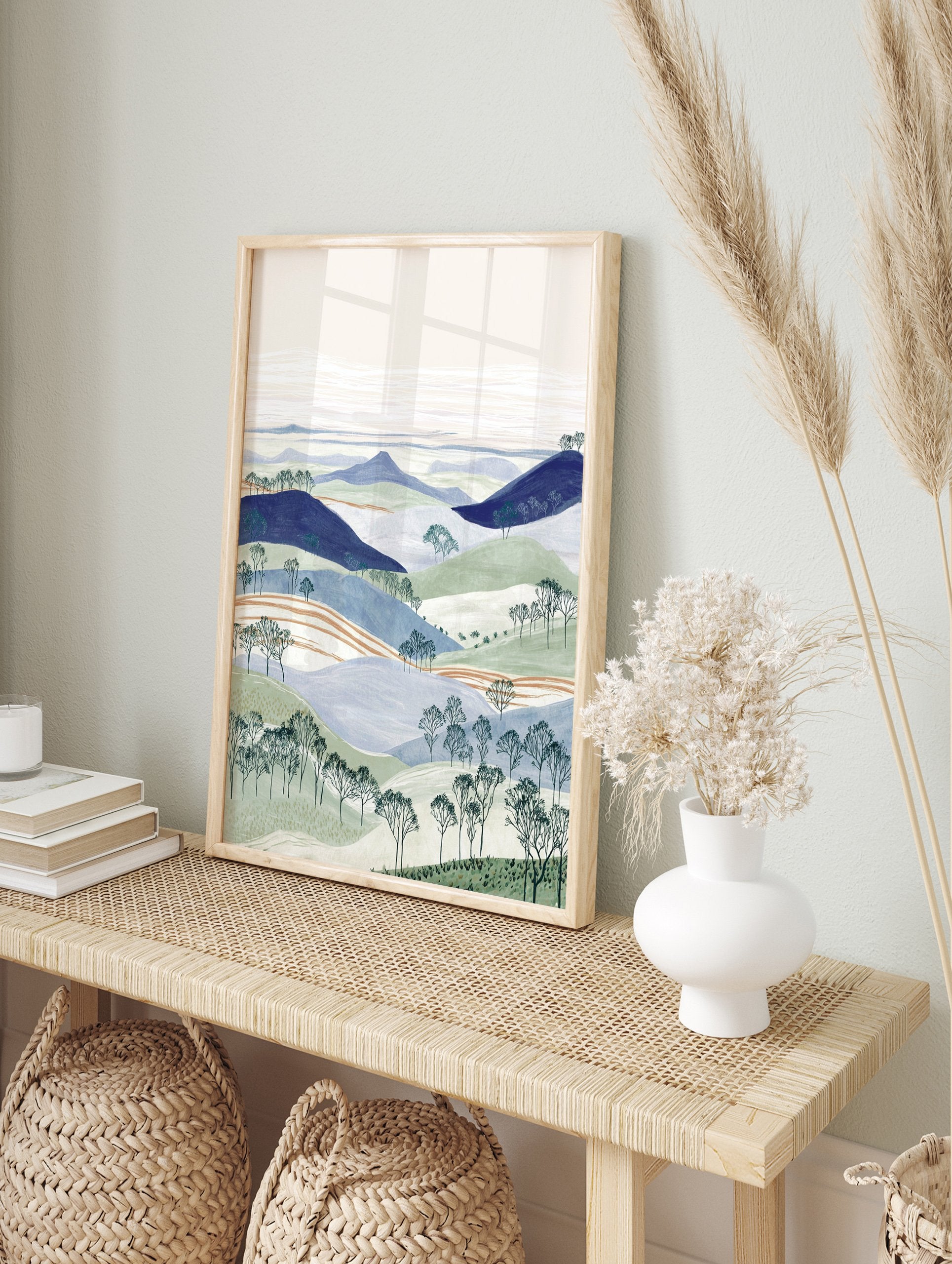 Illustrated landscape wall art with layered blue and green hills, bare trees, and a pale sky. - Image 3