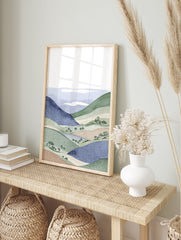 Illustrative landscape wall art print featuring blue and green rolling hills, trees, and white clouds. - Image 3