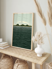 Illustrative landscape wall art print showing green mountains, a light blue sky with clouds, and a dark blue ocean with white waves. - Image 3