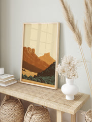 Minimalist illustrative art print of a layered desert mountain landscape with warm earth, in an alternate framed mockup