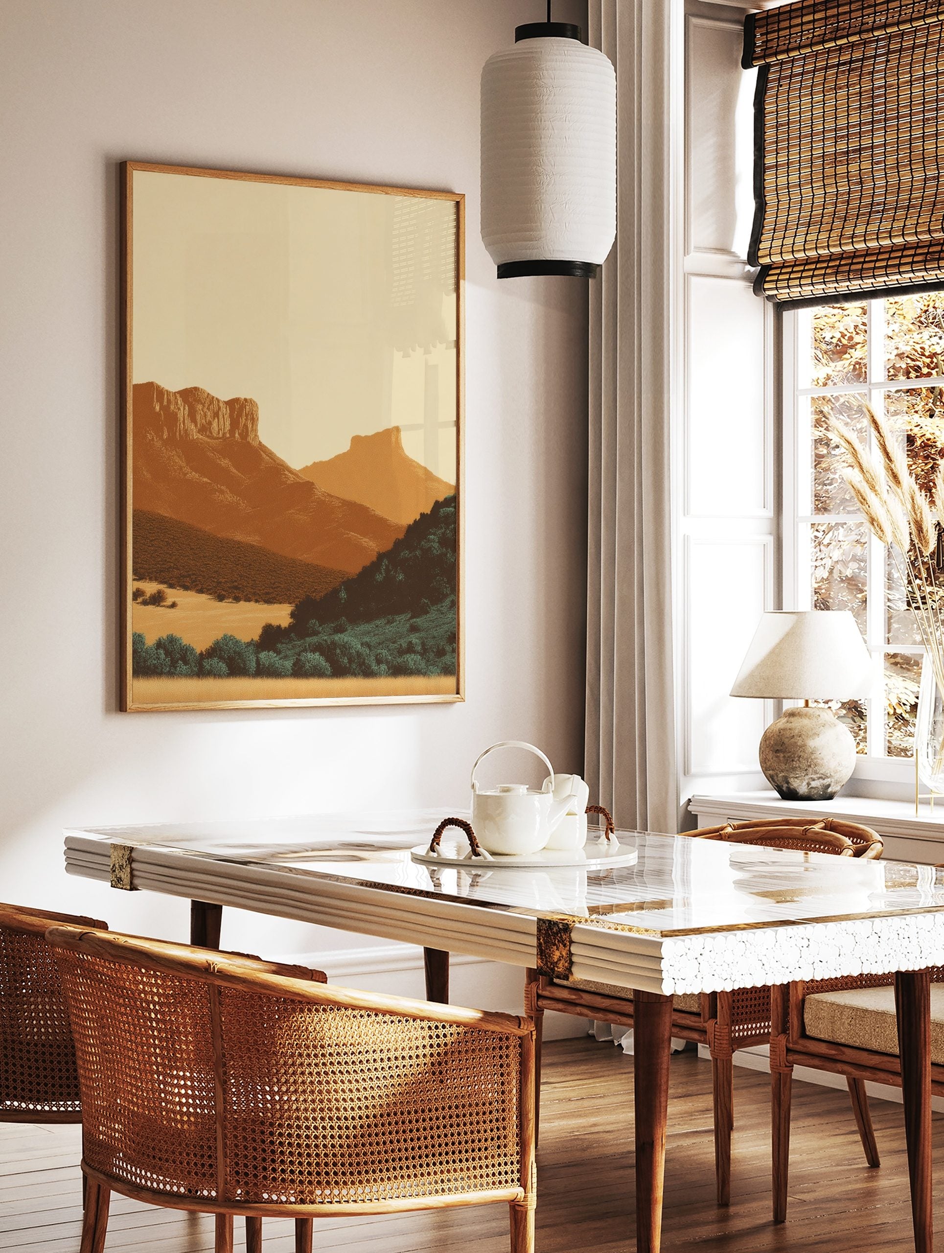 Minimalist illustrative art print of a layered desert mountain landscape with warm earth tones and, in a styled room mockup