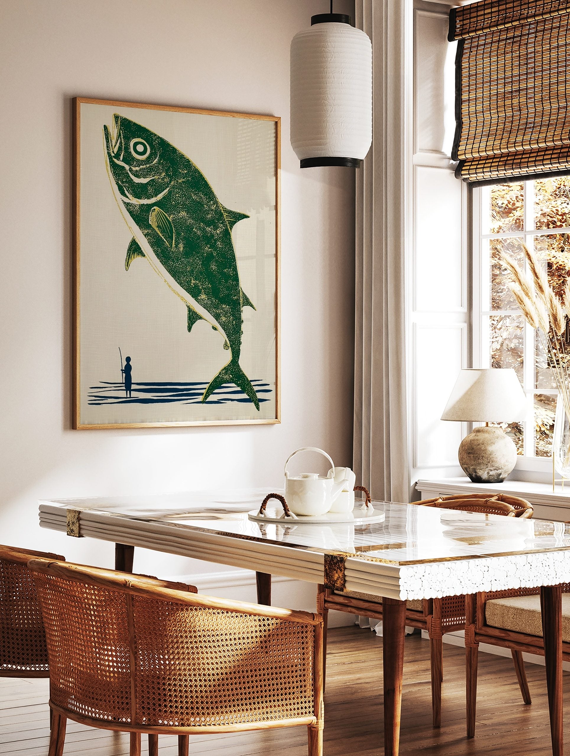 Illustrative print of a large green fish leaping from blue water, with a small fisherman holding a, in a styled room mockup