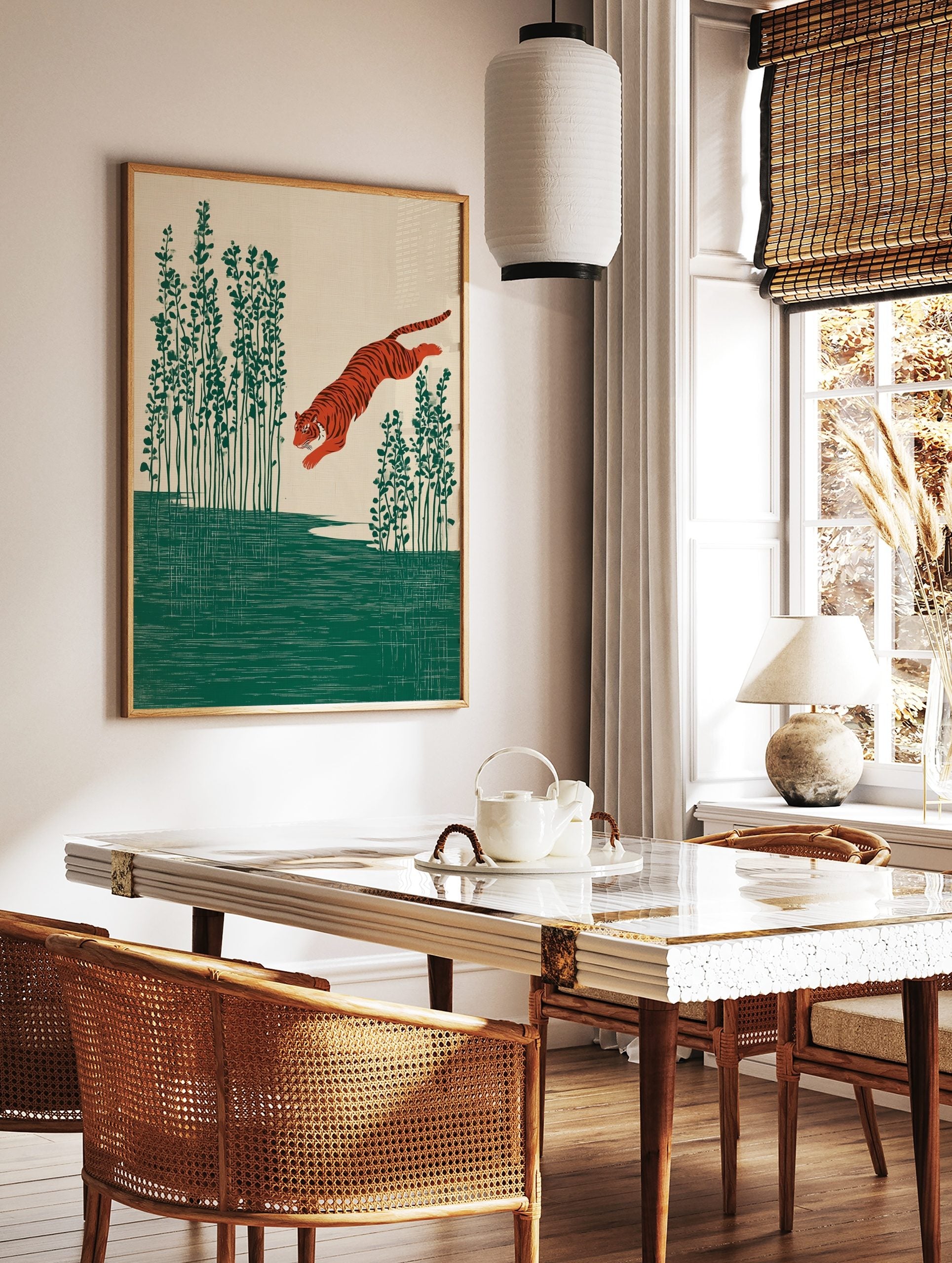 Illustrative print of an orange tiger leaping over green water with tall plants on a beige, in a styled room mockup