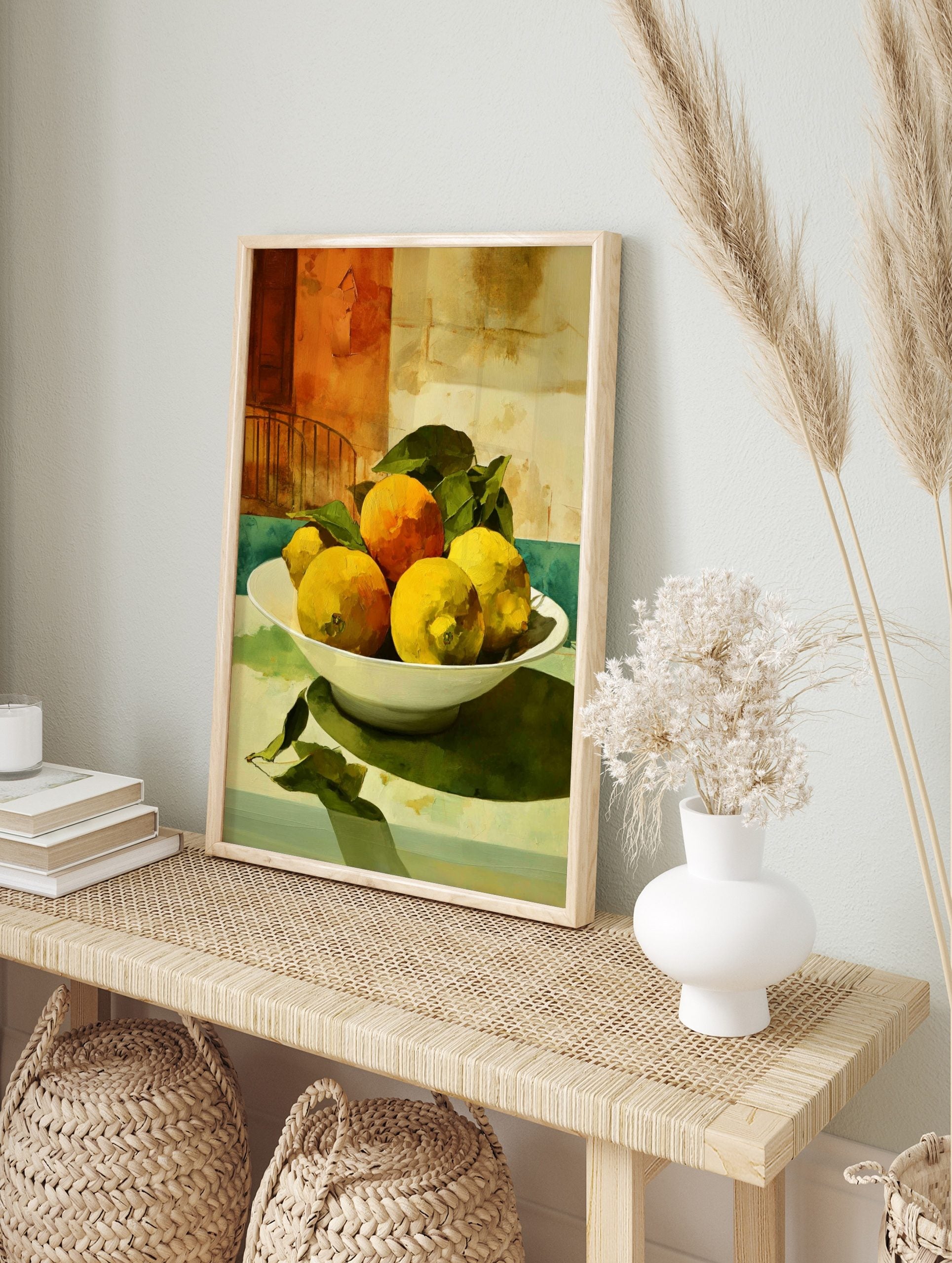 Still life painting of yellow lemons and orange in white bowl with green leaves, against a, in an alternate framed mockup