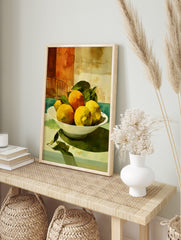 Still life painting of yellow lemons and orange in white bowl with green leaves, against a, in an alternate framed mockup