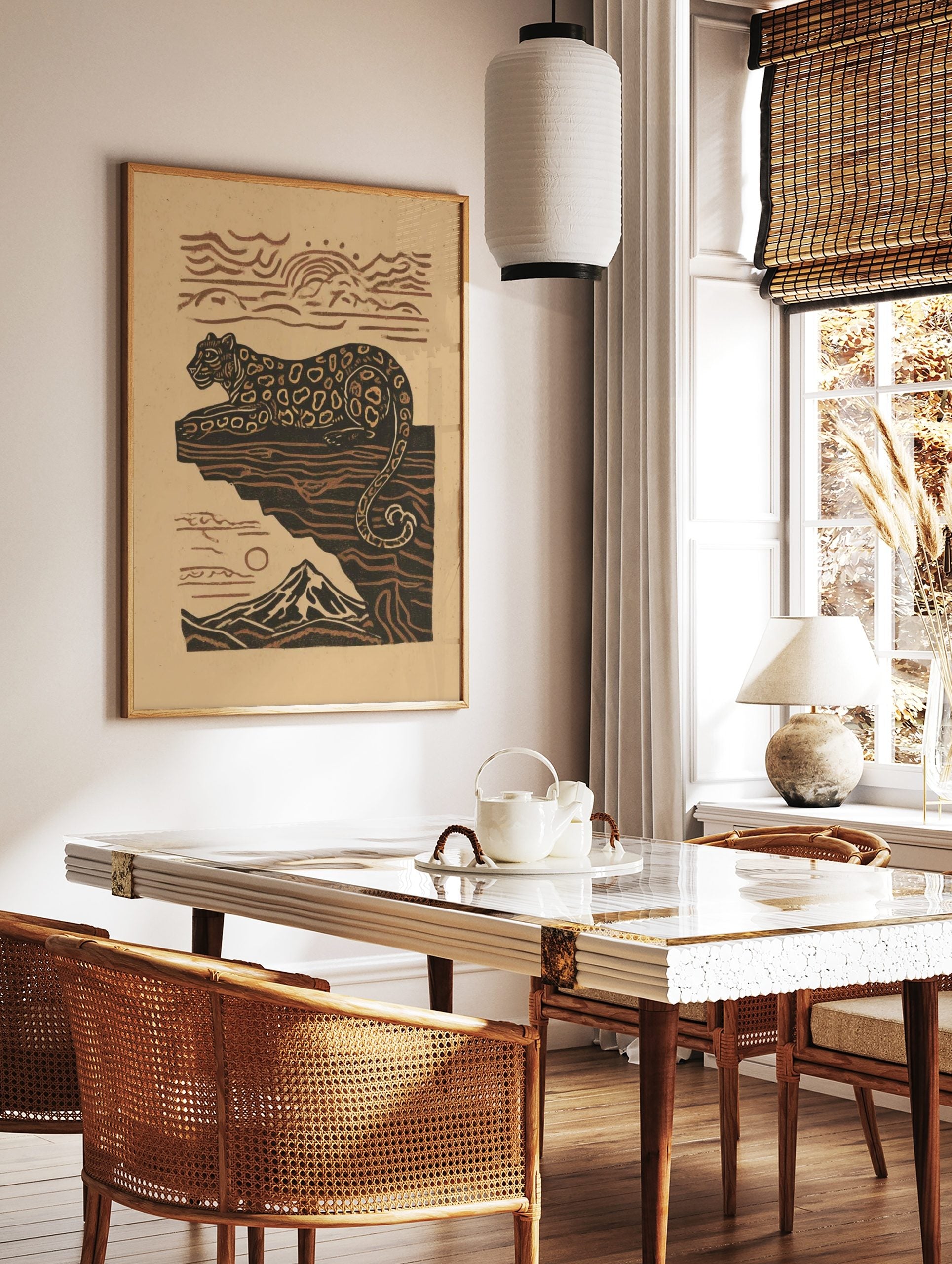Illustrative leopard resting on a cliff with a mountain and sun in earthy brown and beige tones, in a styled room mockup