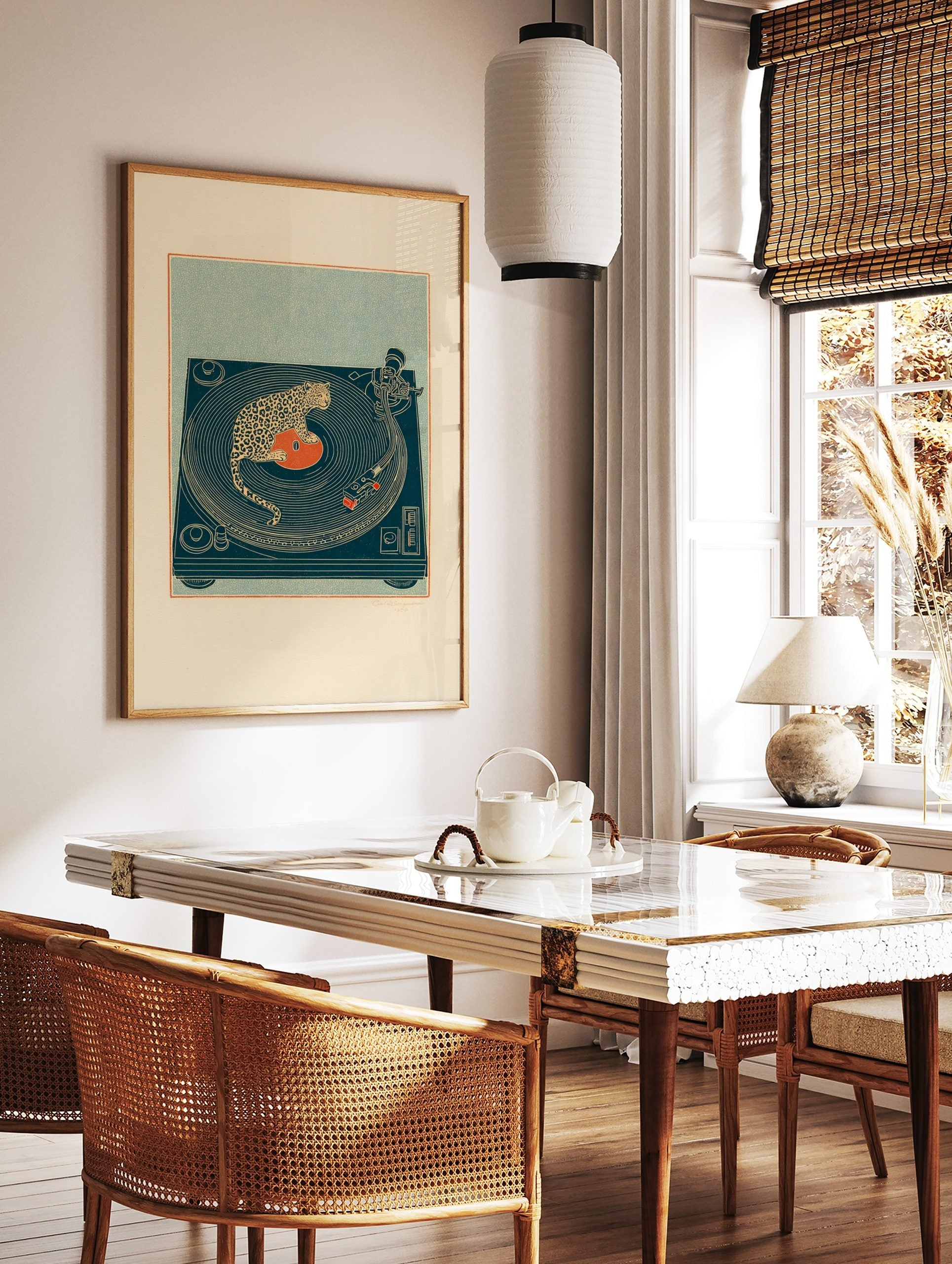 Illustrative print of a spotted leopard sitting on a red vinyl record on a deep teal turntable, in a styled room mockup