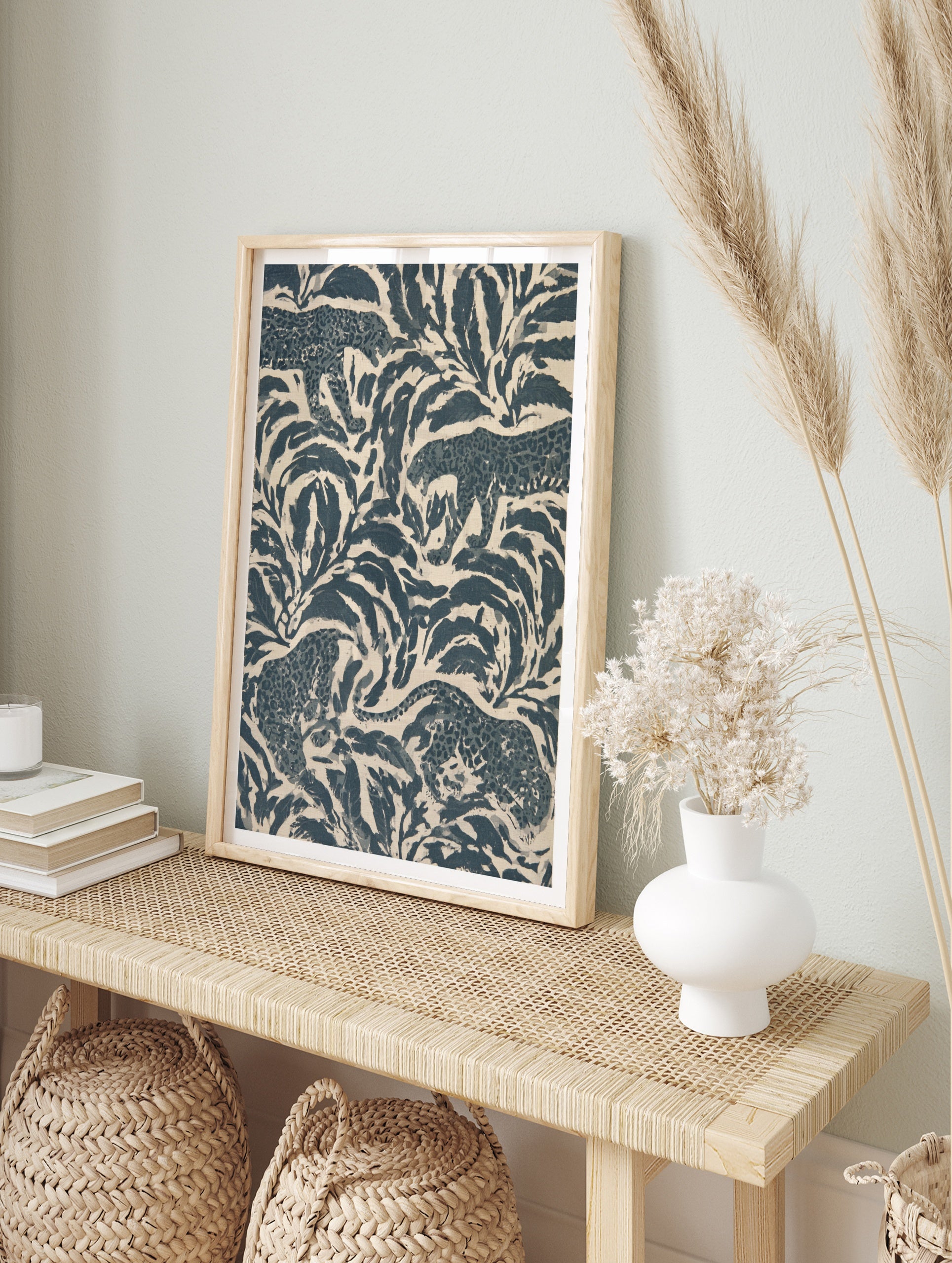 Stylised leopard pattern wall art featuring navy blue jungle foliage and big cats on a cream, in an alternate framed mockup