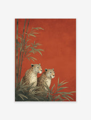 Two illustrative leopards sitting among green bamboo plants against a vibrant textured red background, an elegant Leopard Wall Art print.