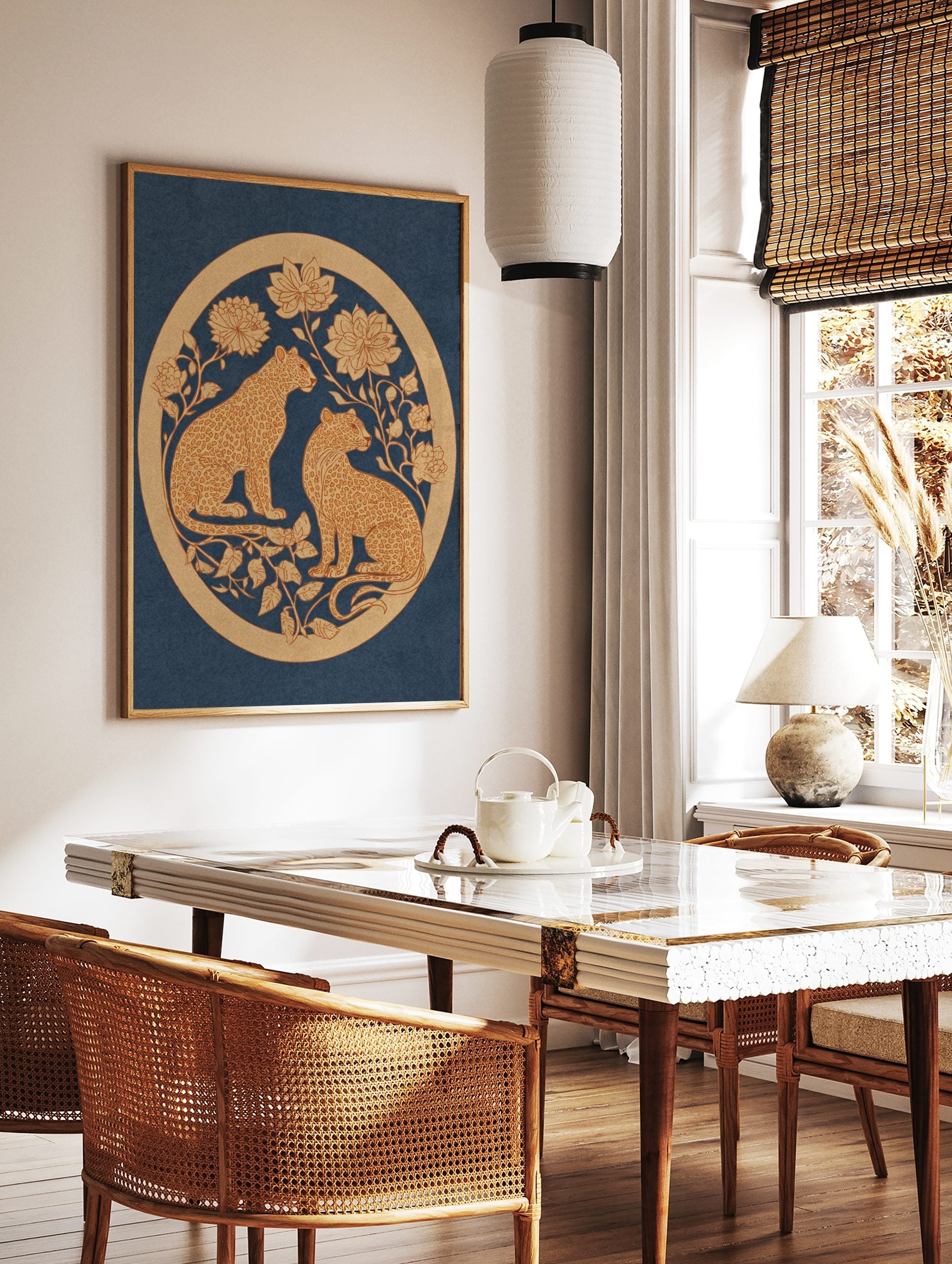 Two golden leopards with ornate floral designs in a circular border on a deep blue background, in a styled room mockup