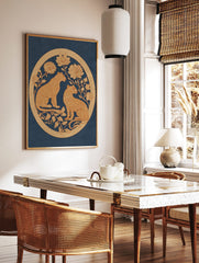 Two golden leopards with ornate floral designs in a circular border on a deep blue background, in a styled room mockup
