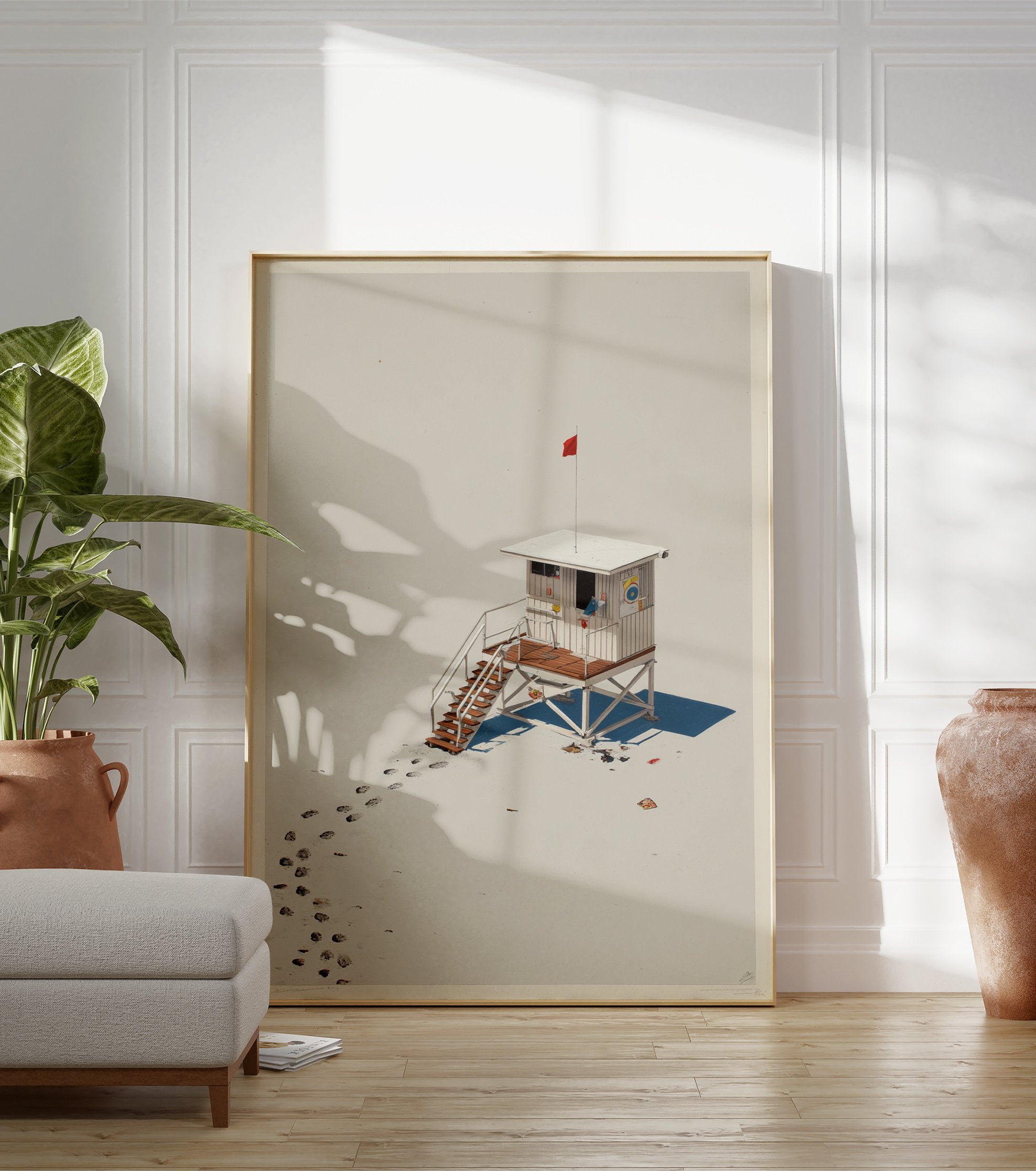 Lifeguard Hut Poster featuring a white hut with a red flag on a beige beach with footprints and shadows. - Image 3