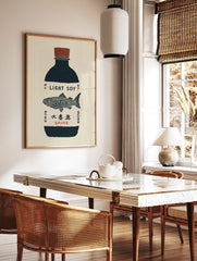 Illustrative print of a dark blue soy sauce bottle with a red cap and detailed fish on a beige, in a styled room mockup