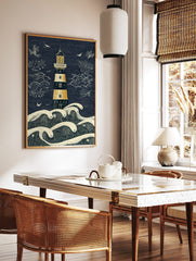 Illustrative lighthouse and crashing waves art print in navy blue, golden yellow, and beige with, in a styled room mockup